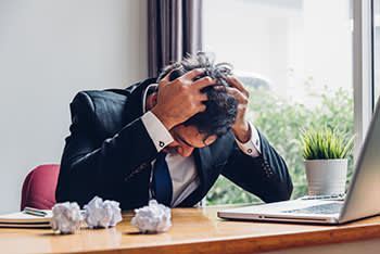 Frustrated man at a computer 