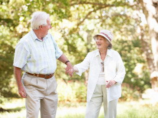 Elderly couple holding hands outside