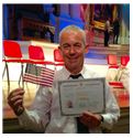 Joey Regan posing with american flag and certificate in Maynard, MA