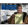 Michael Feeney in front of the John F. Kennedy Federal Building in Boston, Massachusetts with his U.S. citizenship approval notice