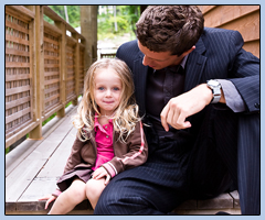 Man in a suit holding a little girl