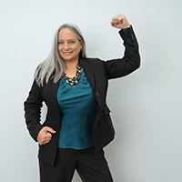 Carolyn N. Budnik posing with her fist in the air