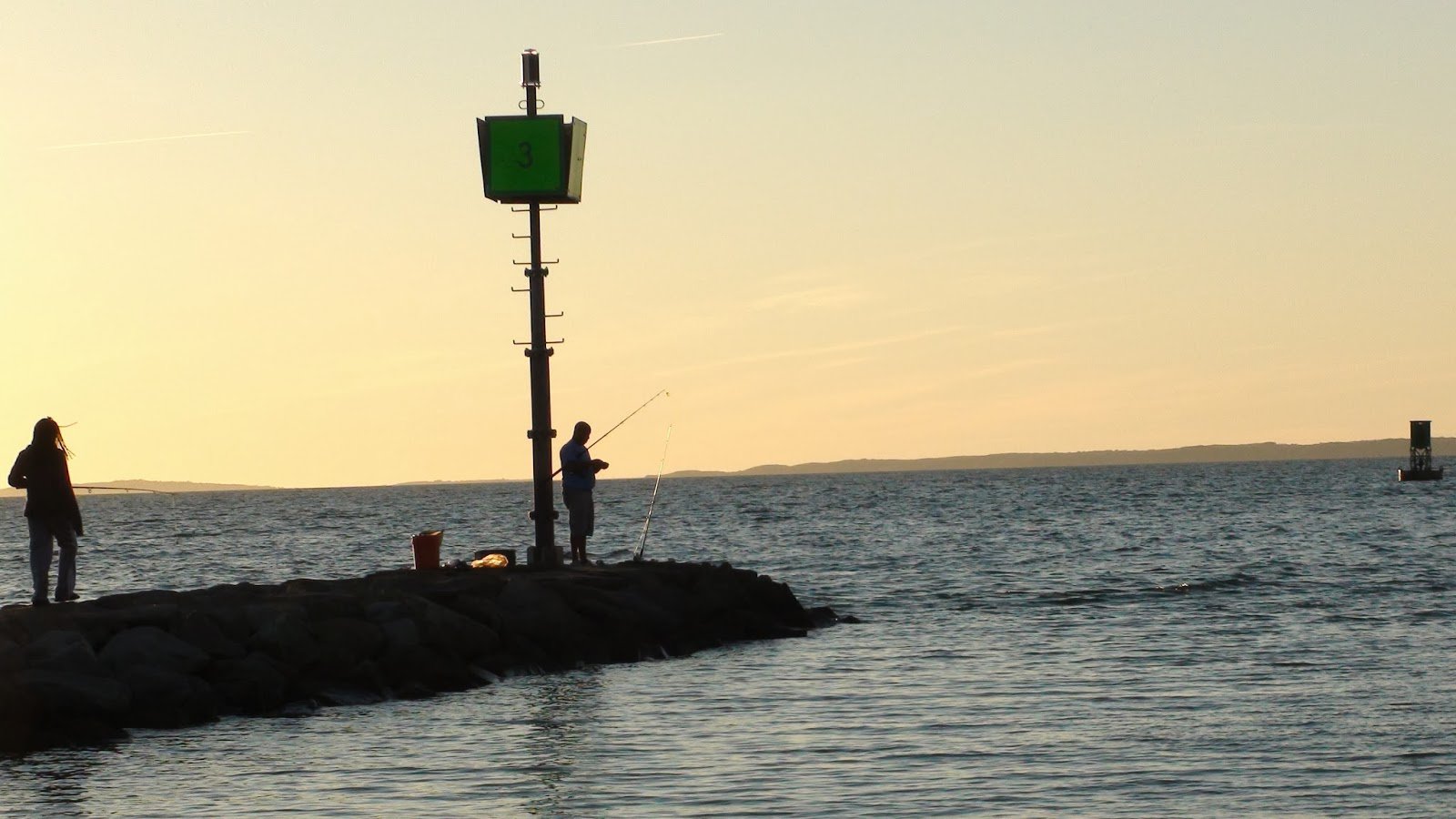 Person fishing at sunrise