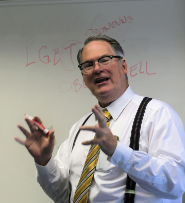 Attorney Tim Cordes standing at a white board and talking
