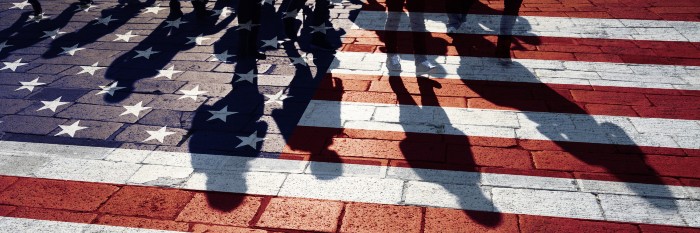 Shadows casted over an American flag on the ground