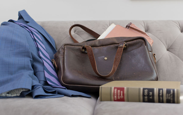 briefcase, suit and legal book on couch