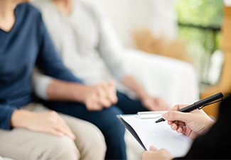 Young Man and Woman Consulting with Professional Consultant