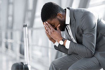 Man sitting with his head in his hands