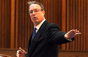 Attorney Paul Oller talking with hand raised