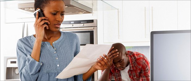 woman looking at document and mans hand on face