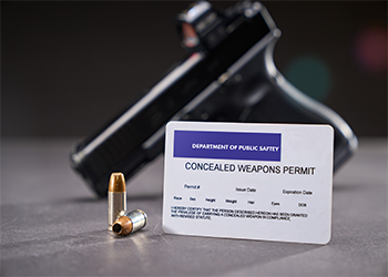  Concealed Carry Permit next to handgun