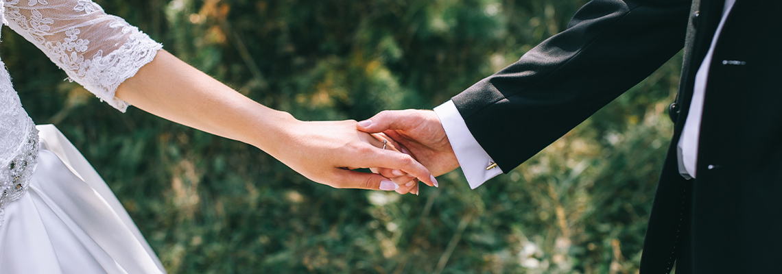 A bride and groom holding hands