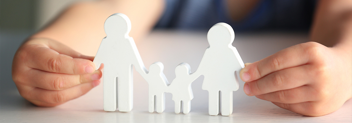 Kid holding a wooden cutout of a family