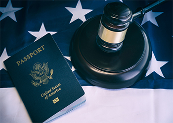 Gavel and passport lying on table with american flag