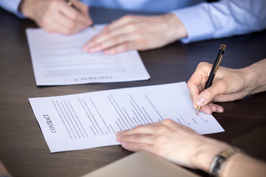 People signing documents