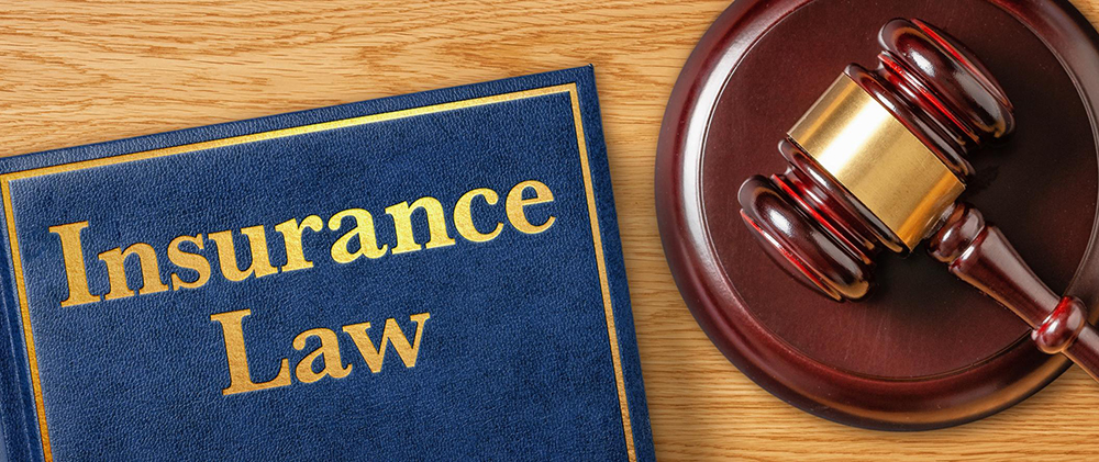 Gavel and book reading Insurance Law