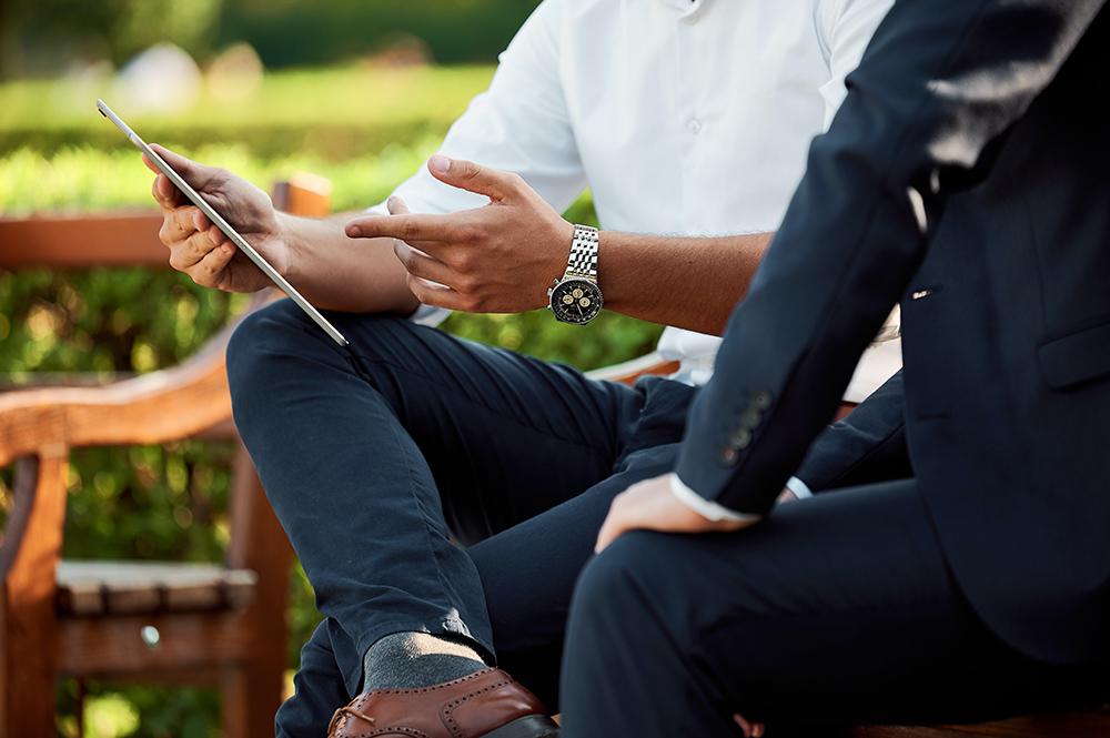 Two people meeting on a park bench