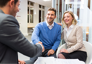 Young couple shaking hand with real-estate agent