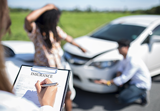 Insurance Agent Examining Car After Accident