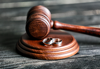 Judge's Gavel and Rings on Wooden Background