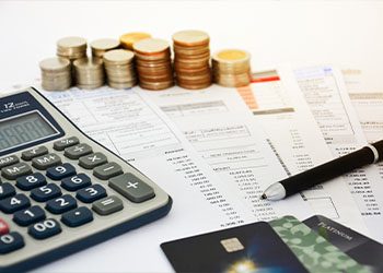 Calculator and papers on a table with credit cards