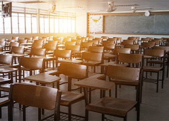 Photo of school classroom with empty chairs