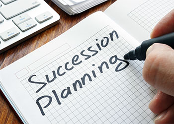 Succession planning written on a notepad