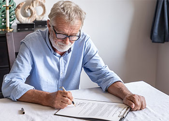 Senior old man signing testament