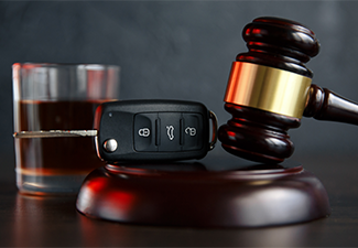 Gavel, Alcohol, and Car Keys on a Table