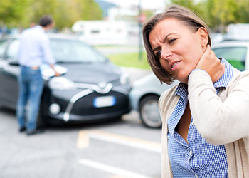 Woman feeling pain after car accident in the city