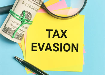 Phrase TAX EVASION written on sticky note
