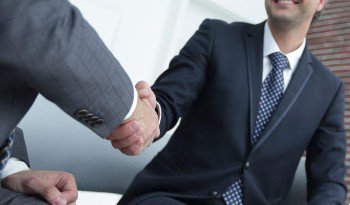 Criminal defense attorney in Irvine shaking hands with a man charged with a white collar crime