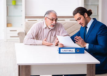 Young male lawyer visiting old man in testament concept