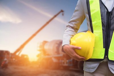 Construction Worker Holding a Helmet