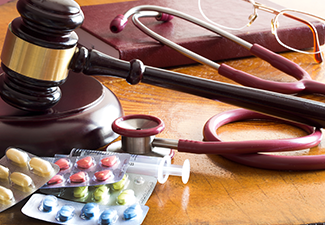 Judges Gavel with Stethoscope and Pills Close Up