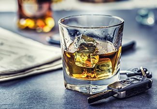 Car Keys and Glass of Alcohol on Table in Pub or Restaurant