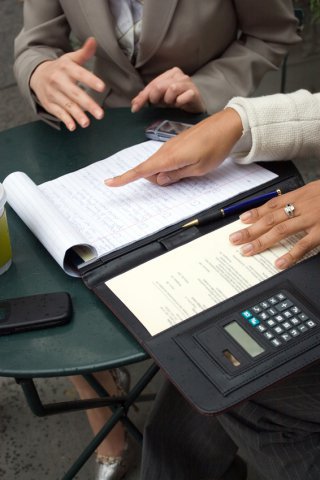 two people reviewing documents in a portfolio