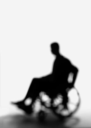 silhouette of a man in a wheelchair