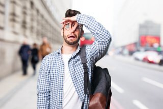 man plugging his nose