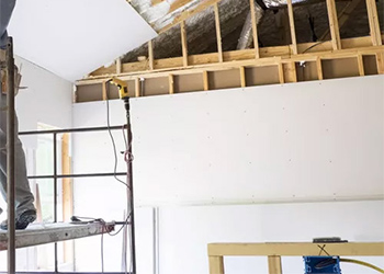 Man standing on scaffold in a building