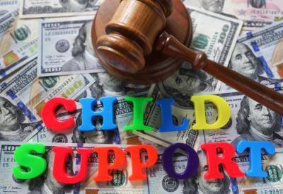 Child support spelled out in magnets with gavel