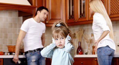 Parents fighting with child covering her ears