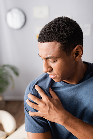 Man holding his right shoulder