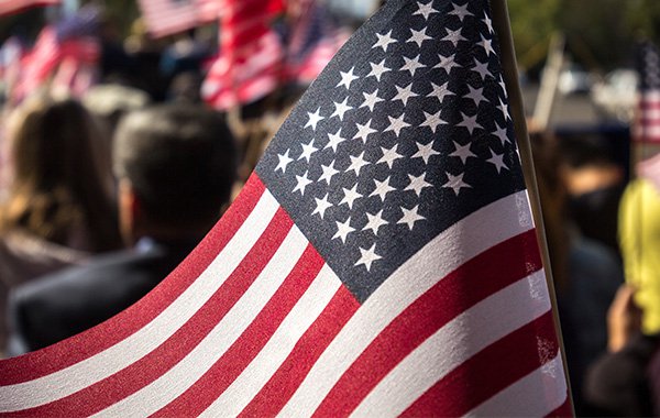 People at a rally holding flags