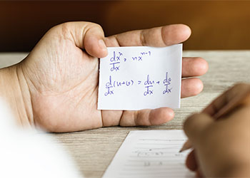 Student using formula math sheet to cheat on test