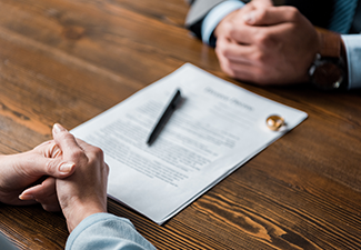 Lawyer and Client Sitting at Table with Divorce Decree