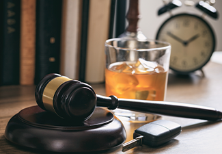 Law Gavel, Alcohol and Car Keys on A Wooden Desk