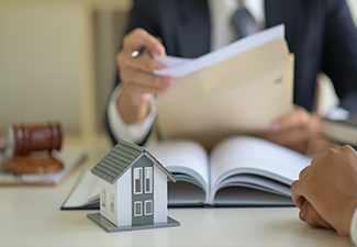 The lawyer is consulting clients about the house purchase contract.