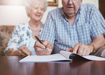 Senior couple signing their will documents