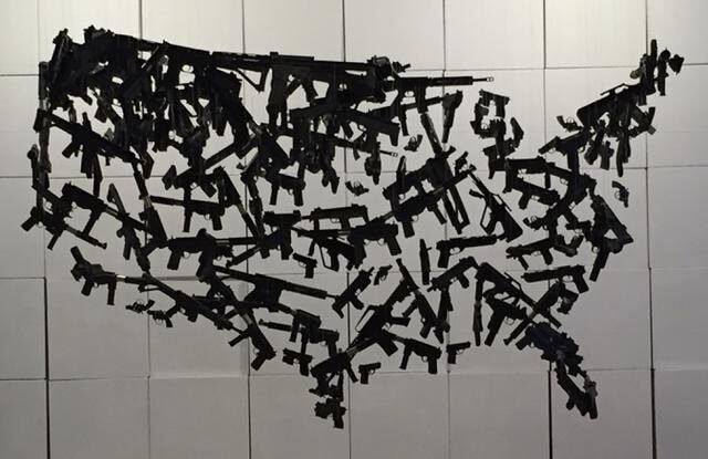 Hanging sculpture of guns in shape of United States